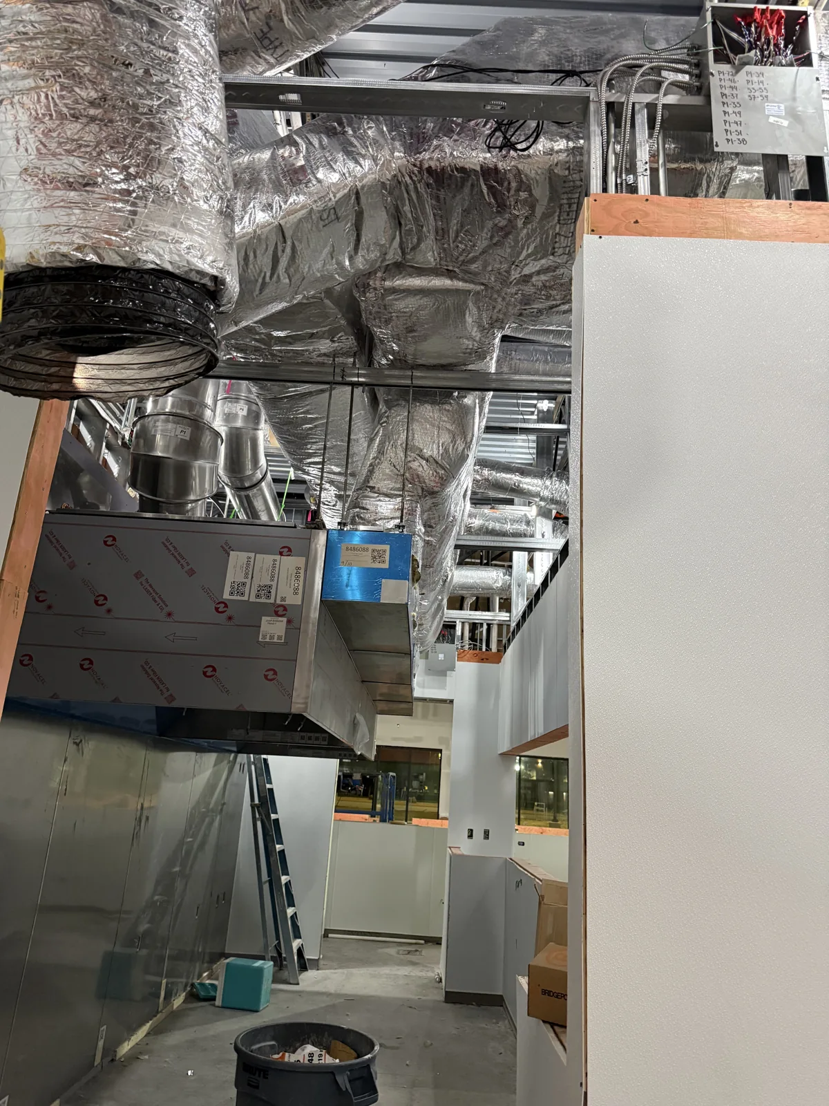 HVAC equipment and insulated ductwork inside a building under construction